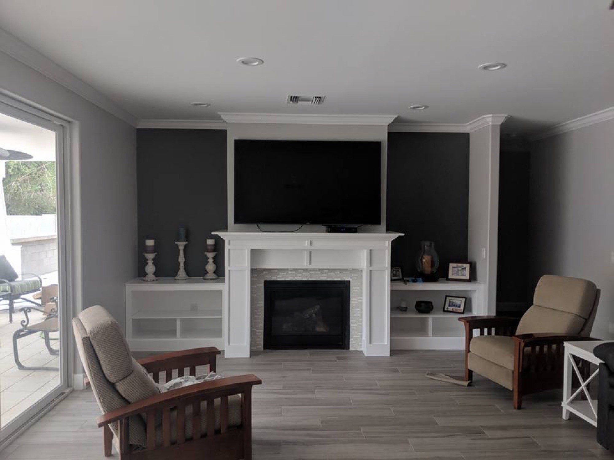White fireplace mantel with flanking built-in shelving